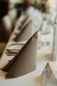 Close-up of a sophisticated table setting featuring a folded napkin, creating a refined atmosphere for an event or dinner.