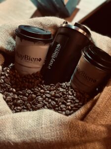 Three coffee cups surrounded by coffee beans on burlap, creating a cozy and rustic atmosphere.