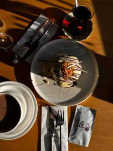 Appetizing dessert with beverage on sunlit table, perfect for dining themes.
